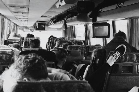Coach Tour Driver needed in Greater Manchester A monochrome view inside a bus full of seated passengers on a journey.