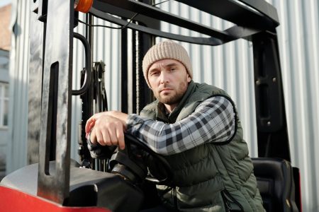 Forklift Operator needed in Bristol Adult male forklift operator in casual wear working outdoors. Sunlit environment.