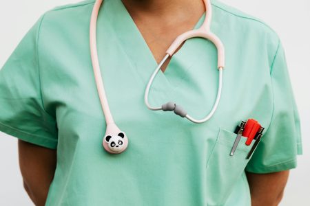 Registered Nurse needed in Eastbourne (Visa Sponsorship Available) Close-up of a medical professional wearing scrub suit and panda-themed stethoscope