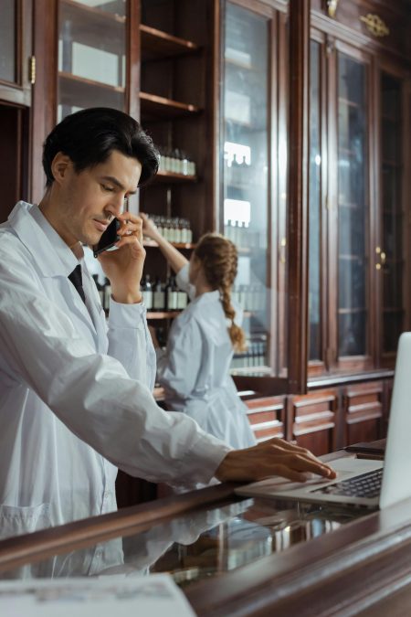 Healthcare Assistant needed in Rochester (Visa Sponsorship Available) Pharmacists working in a historic pharmacy, focusing on customer calls and inventory.