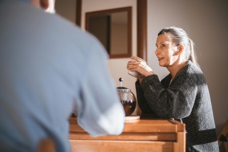 Healthcare Assistant needed in Harrow (Visa Sponsorship Available) Cheerful senior couple enjoying coffee together in a cozy home setting.