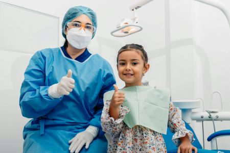 Registered Paediatric Nurse needed in Cottingham (Visa Sponsorship Available) Child and dentist smiling with thumbs up at a dental clinic in Ecuador.