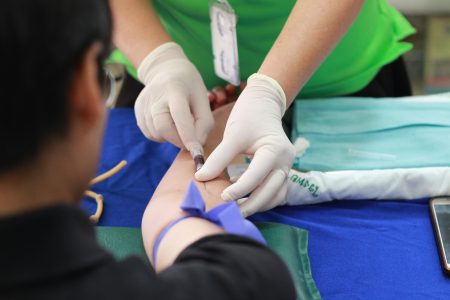 Paediatric Registered Nurse needed in Hull (Visa Sponsorship Available) A healthcare professional administering an injection to a patient's arm during a medical procedure.