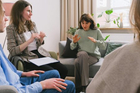 Highly Specialist Applied Psychologist needed in Durham (Visa Sponsorship Available) Women in casual clothes sitting on sofa and speaking during group psychotherapy session in cozy office