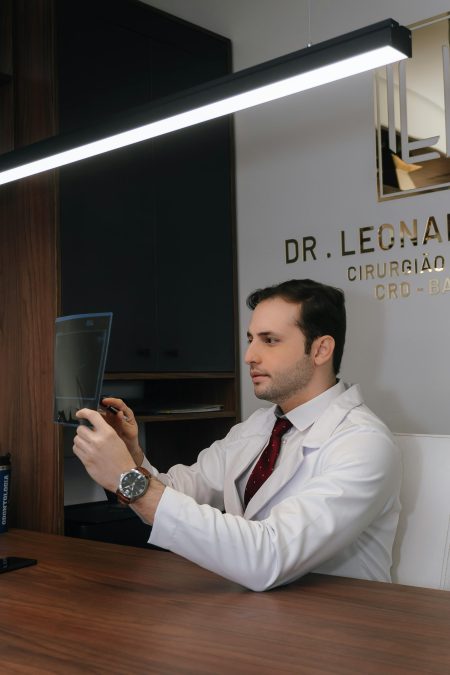 Consultant Radiologist in Gynaecology needed in Doncaster (Visa Sponsorship Available) Medical professional examining radiographic image in clinical office setting.