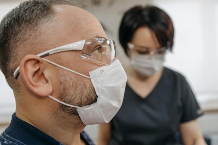 Healthcare Assistant needed at Brixham (Visa Sponsorship Available) Close view of healthcare workers wearing facemasks and goggles for protection.