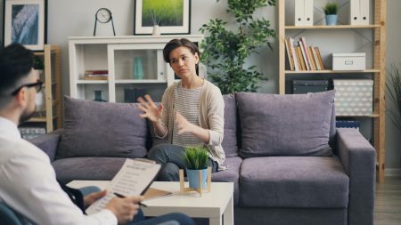 A woman consulting with a therapist in a contemporary office setting.