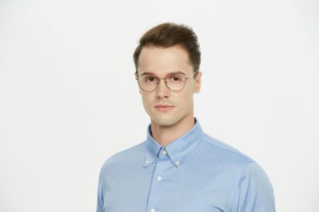 Professional portrait of a man wearing glasses and a blue shirt, isolated on white background.