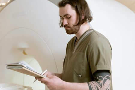 A focused radiologist reviews MRI scan results in a medical facility.